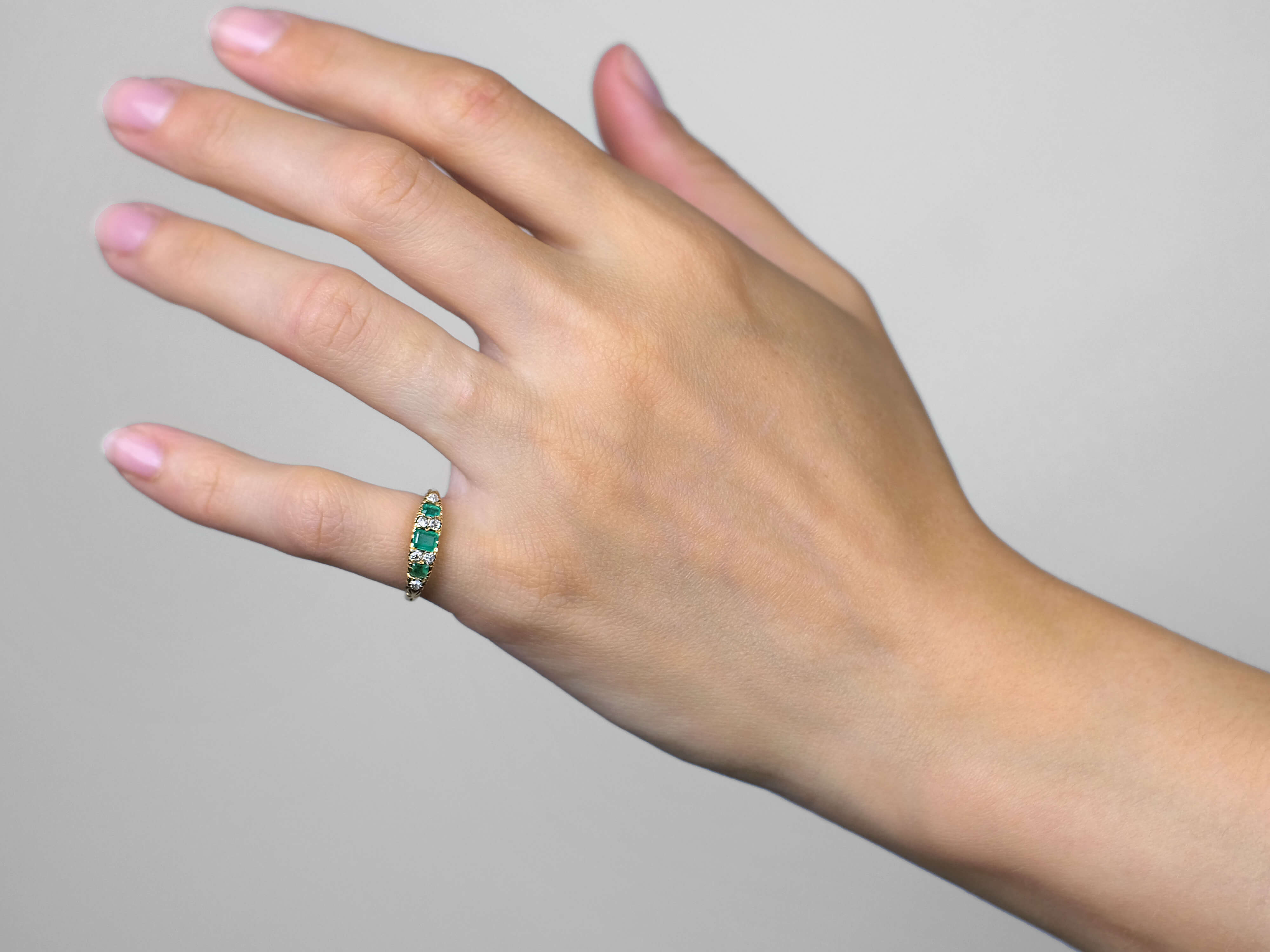 A half hoop Emerald and Diamond ring