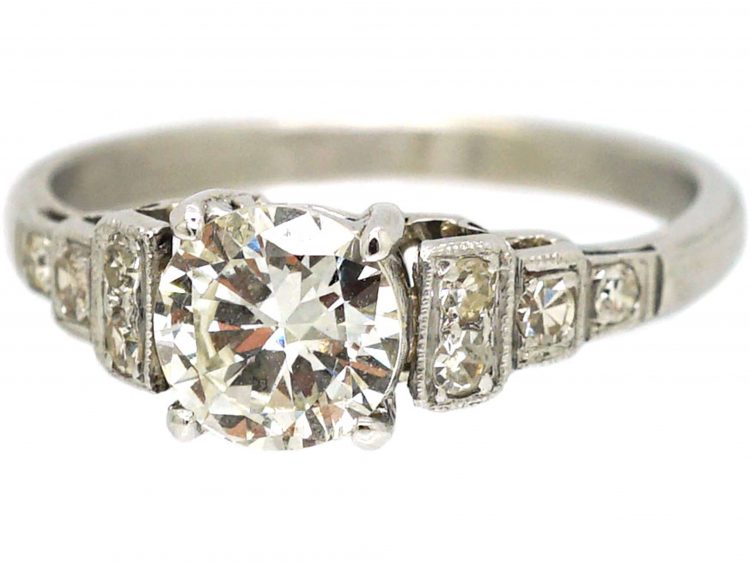 Art Deco Platinum Solitaire Diamond Ring with Step Cut Shoulders set with Diamonds