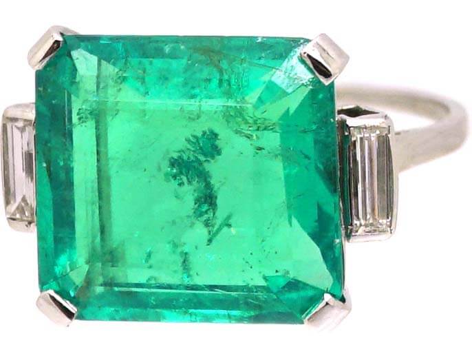 Art Deco Platinum Ring set with a Large Colombian Emerald with Diamond Baguette Shoulders