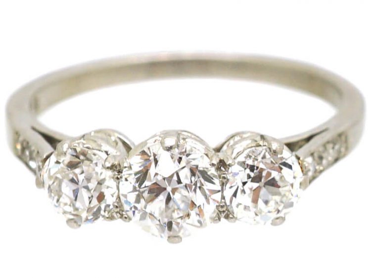 Early 20th Century Platinum, Three Stone Diamond Ring with Diamond Set Shoulders