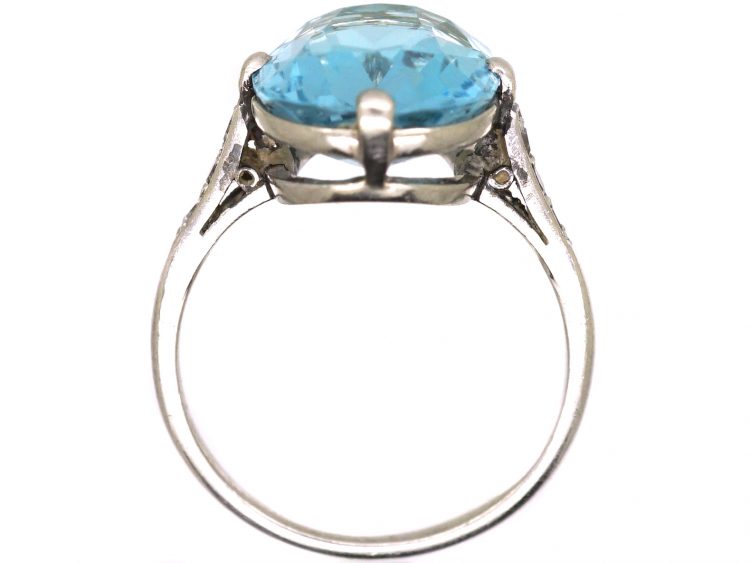 Early 20th Century Platinum Ring set with an Aquamarine with Diamond Set Shoulders