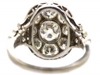 Early 20th Century Large 18ct White Gold Large Oval Diamond Cluster Ring with Diamond Set Step Cut Shoulders
