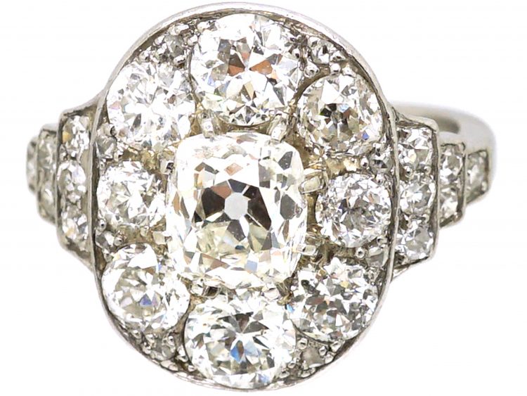 Early 20th Century Large 18ct White Gold Large Oval Diamond Cluster Ring with Diamond Set Step Cut Shoulders