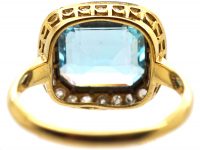 Edwardian 18ct Gold & Platinum Ring set with an Aquamarine with a Diamond Border
