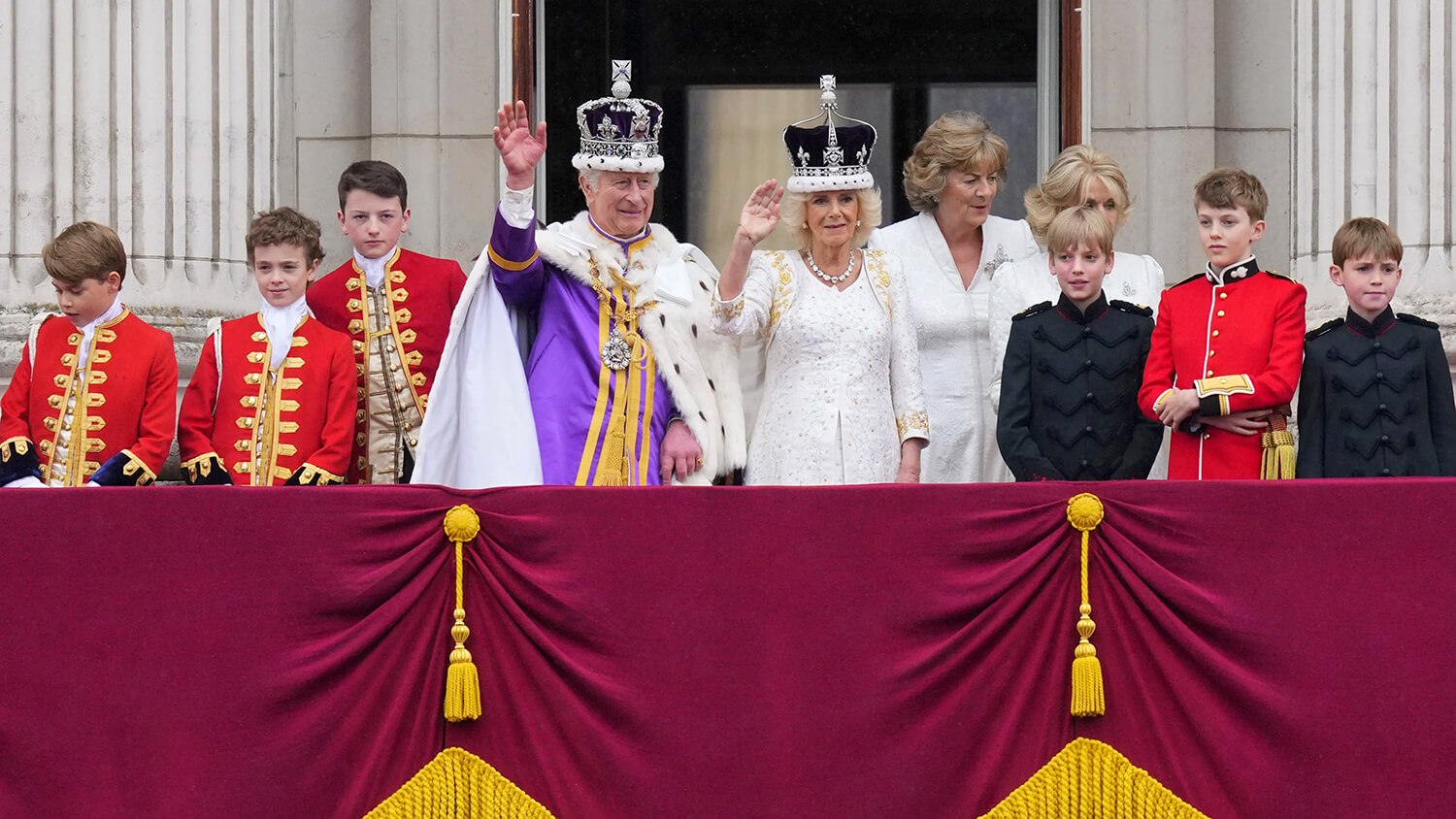 King Charles III and Queen Camilla wave to the crowds from the balcony of Buckingham Palace after their coronation ceremony, in London, Saturday, May 6, 2023