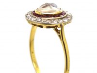 Early 20th Century 18ct Gold & Platinum, Man in the Moon Ring set with a Moonstone, Rose Diamonds & Rubies