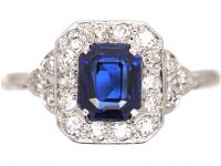 Platinum Diamond Cluster Ring Set With An Emerald Cut Sapphire