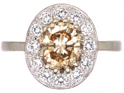 Mid 20th Century 18ct Gold Cluster Ring set with a Cognac Diamond within an Oval Ring of Diamonds