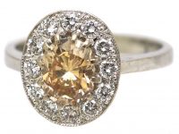 Mid 20th Century 18ct Gold Cluster Ring set with a Cognac Diamond within an Oval Ring of Diamonds
