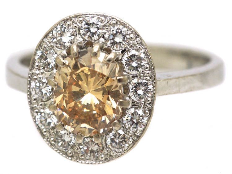 Mid 20th Century 18ct Gold Cluster Ring set with a Cognac Diamond within an Oval Ring of Diamonds