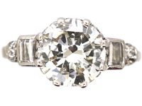 Art Deco Platinum Diamond Solitaire Ring with Baguette Cut Diamond Step Cut Shoulders