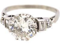 Art Deco Platinum Diamond Solitaire Ring with Baguette Cut Diamond Step Cut Shoulders