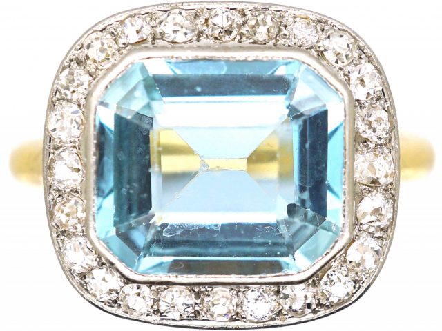 Edwardian 18ct Gold & Platinum Ring set with an Aquamarine with a Diamond Border